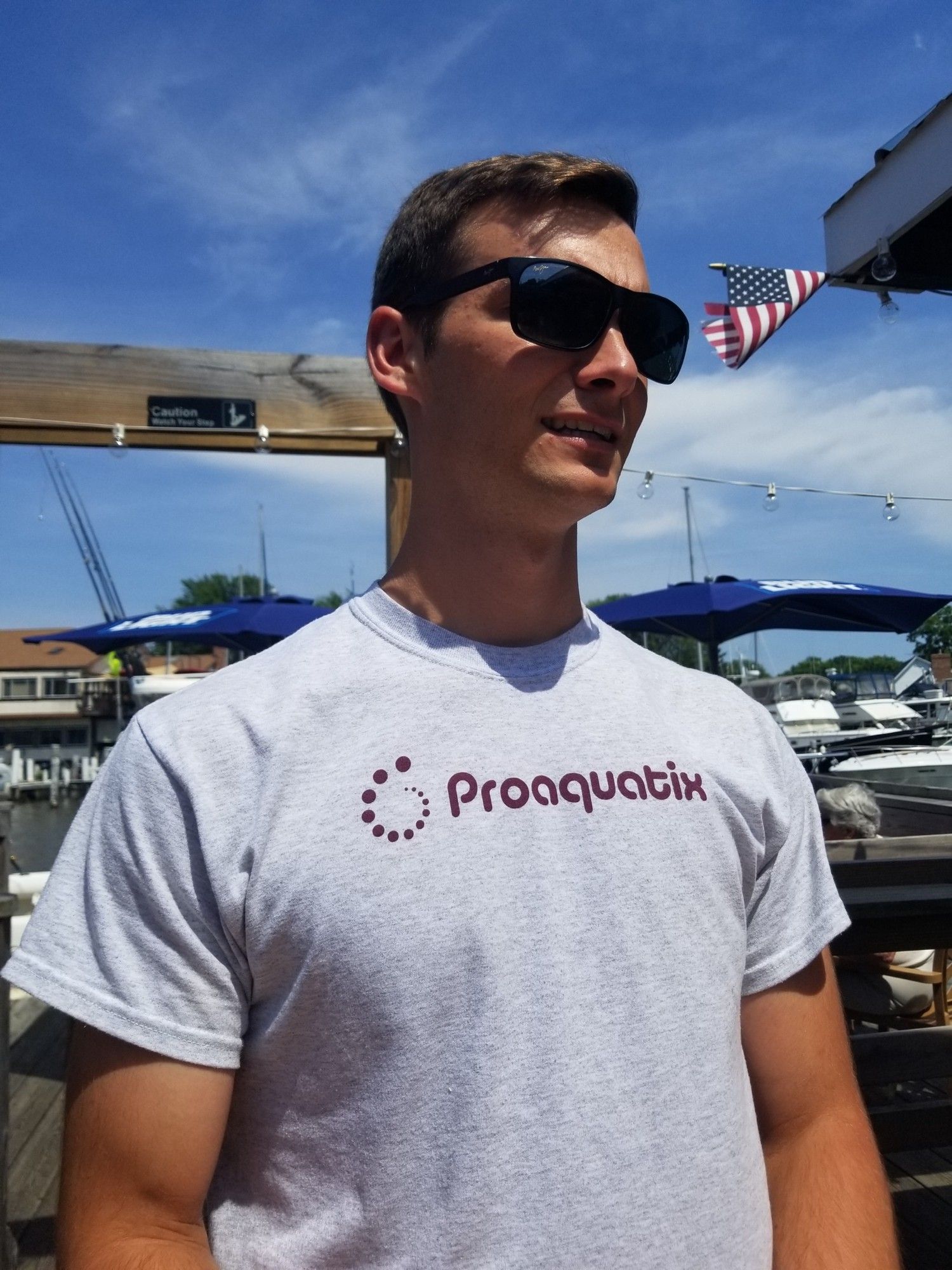 man with grey proaquatix t-shirt and sunglasses